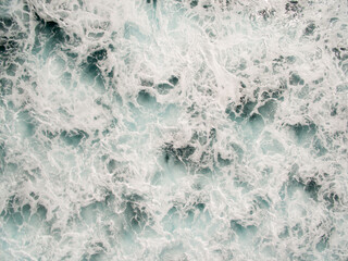 overhead view of sea foam forming on the ocean as the wind and waves agitate the surface