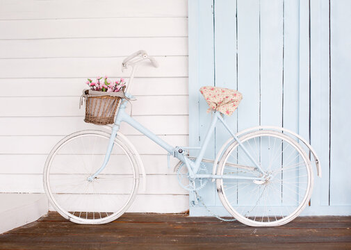 White Bicycle With Beautiful Flower Basket on vintage background in spring season