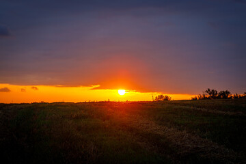 Naklejka na ściany i meble Sunset over a field in Ukraine