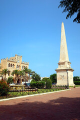 Ciutadella, Menorca (Minorca), Spain. Obelisc placed in the center of Plaza del Borne and City Hall building in Ciudadella de Menorca.
