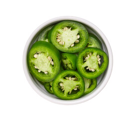 Fresh green cut chili pepper pieces in a white ceramic bowl isolated on white background, top view.