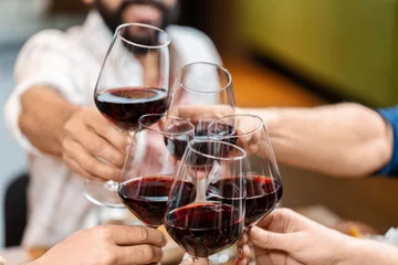 Keuken spatwand met foto leisure, people and celebration concept - close up of happy friends drinking red wine and toasting at restaurant or pub © Syda Productions
