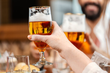 leisure, people and celebration concept - close up of happy friends having dinner and drinking beer at restaurant or pub