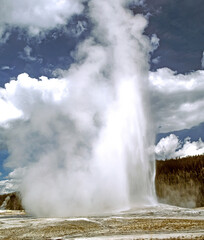 Old faithful geiser erupts every hour in Yellowstone National Park, Wyoming,