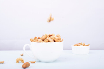 Roasted cashew nut in bowl isolated on white background