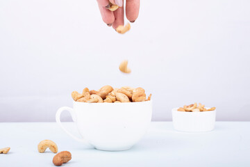 Roasted cashew nut in bowl isolated on white background