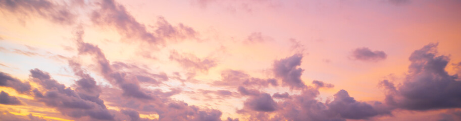 The pinkish colors of the sunset and the clouds. Evening time in panoramic sky