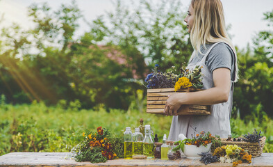 Woman with medicinal herbs and tinctures. Selective focus.