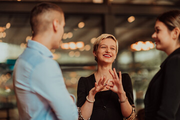 Photo of a business team of young people discussing business ideas in a modern urban environment. Selective focus 