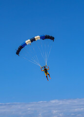 Skydiver flying over the beach