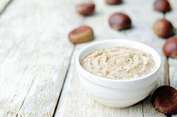Fresh homemade chestnut paste on a wood background