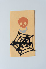 paper skull and crossbones with spider web