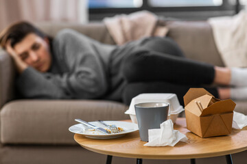 mental health, psychological problem and depression concept - close up of takeaway food on table...