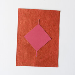 paper square or diamond isolated on an orange card