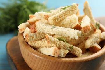 Delicious hard chucks with dill in wooden bowl, closeup