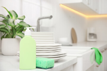 Clean dishes and cleaning product in stylish kitchen