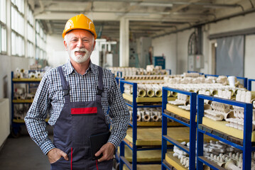 Senior man blue collar worker working in the factory