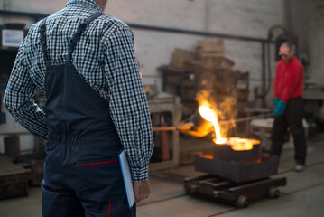 Senior man blue collar worker working in the factory