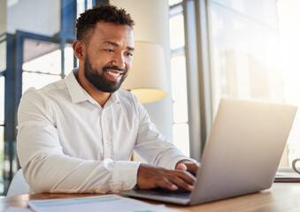 Laptop, business and technology with a corporate man at work on a computer at his desk in an office. Innovation, mission and vision with an employee working with motivation and focus toward a goal.
