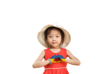 Little girl wear hat showing heart sign with his hands painted in Ukraine flag color isolated on transparent background - PNG format. Stop the war for peace. Love Ukraine concept.