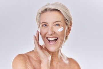 Beauty, skincare and wellness with a senior woman applying lotion, sunscreen or serum to her face...