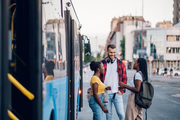 Multiracial group of people waiting for a public transport on a bus station