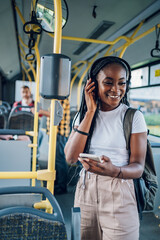 African american woman using smartphone while riding a bus