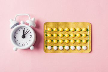 medicine birth control, alarm clock and contraceptive pills