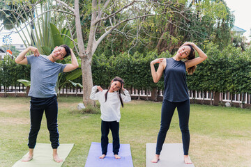 Obraz premium mother, father and child daughter practicing exercising stretching together before yoga