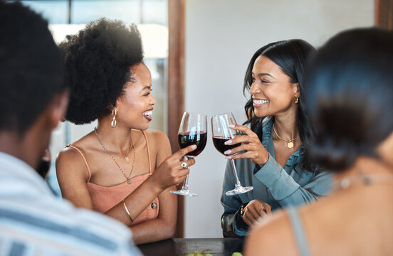 Friends having fun and drinking wine, toasting, bonding and celebrating at an event or party. Diverse friends cheers and laughing, enjoying free time, dining experience and wine tasting gathering