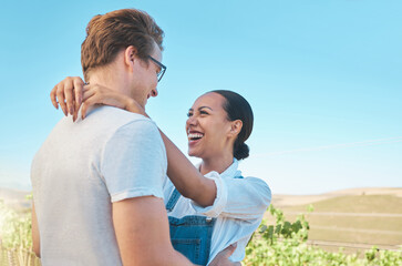 Laughing, in love and happy interracial couple in hug, embrace or holding each other on wine tasting farm. Fun, playful or loving man and woman standing close and enjoying countryside vineyard estate - Powered by Adobe
