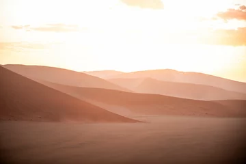 Zelfklevend Fotobehang dramatic sunset over sand dunes in namibia © Zach