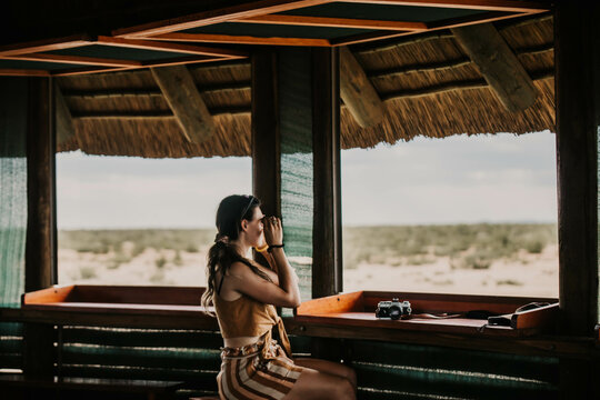 female tourist using binoculars on safari in africa
