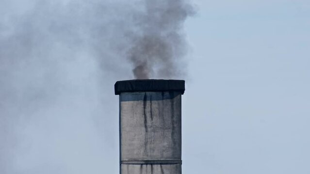 Dark Brown Smoke Coming Out Chimney Produced by Burning Low Quality Coal and Garbage 
