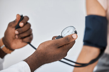 Blood pressure or hypertension test by a healthcare professional on a female at the clinic or...
