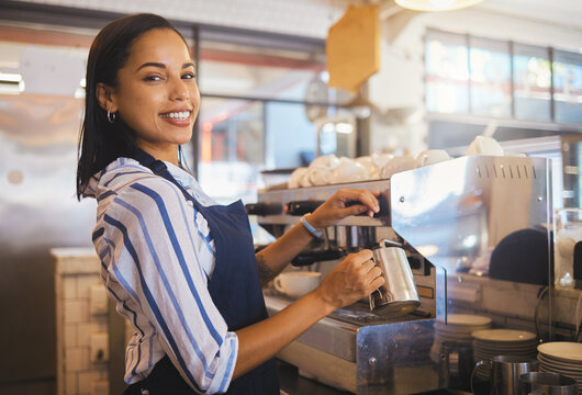 Barista preparing drink in coffee shop, cafe startup and hospitality restaurant. Portrait of friendly waitress, happy bistro worker and young woman steaming milk for hot cappuccino and waiter service