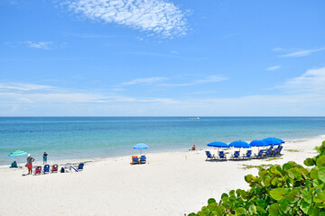 Fototapeta na wymiar Chairs and umbrellas on Vero Beach, Florida on Hutchinson Island