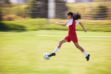 Football, soccer and running girl with a ball doing a sport exercise, workout and training. Moving and young woman athlete in a sports player team uniform runing for fitness cardio on a grass field