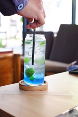 a glass of drinks on the table 