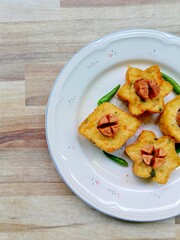 indonesian fried snack called tahu fantasi on a white plate