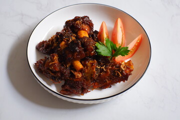 a plate of grilled beef ribs served with vegetables 
