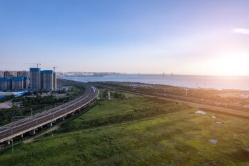 Fototapeta premium High-speed train passes through railway bridge in modern Chinese city