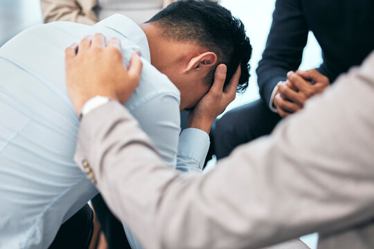 Support and empathy for suffering from mental health, .anxiety and depression businessman in group therapy. Love, care and trust from friends or coworkers for sad man in stress and pain from bad news