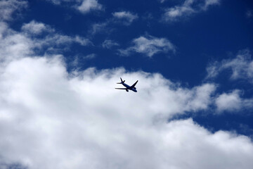 Fototapeta na wymiar A passenger airplane flying into the clouds and sky