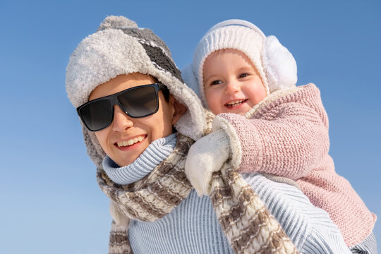 Portrait of happy children in winter. Joyful boy and girl in a rustic style are having fun during the winter Christmas holidays outdoors.
