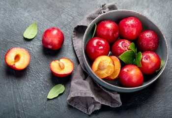 Fresh red plums in plate.