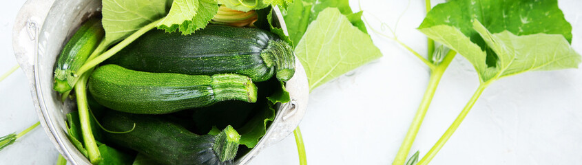 Composition with zucchini on neutral background.