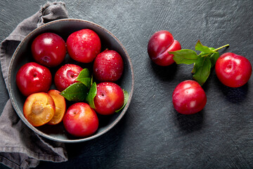 Fresh red plums in plate.