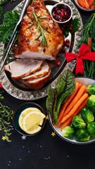Traditional Christmas dinner on dark background.