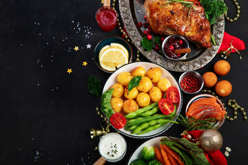 Traditional Christmas dinner on dark background.